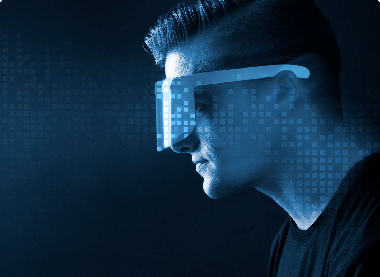 A man wearing futuristic digital glasses visualizing data in a blue tech environment, representing advanced digital twin services and virtual simulation technology.