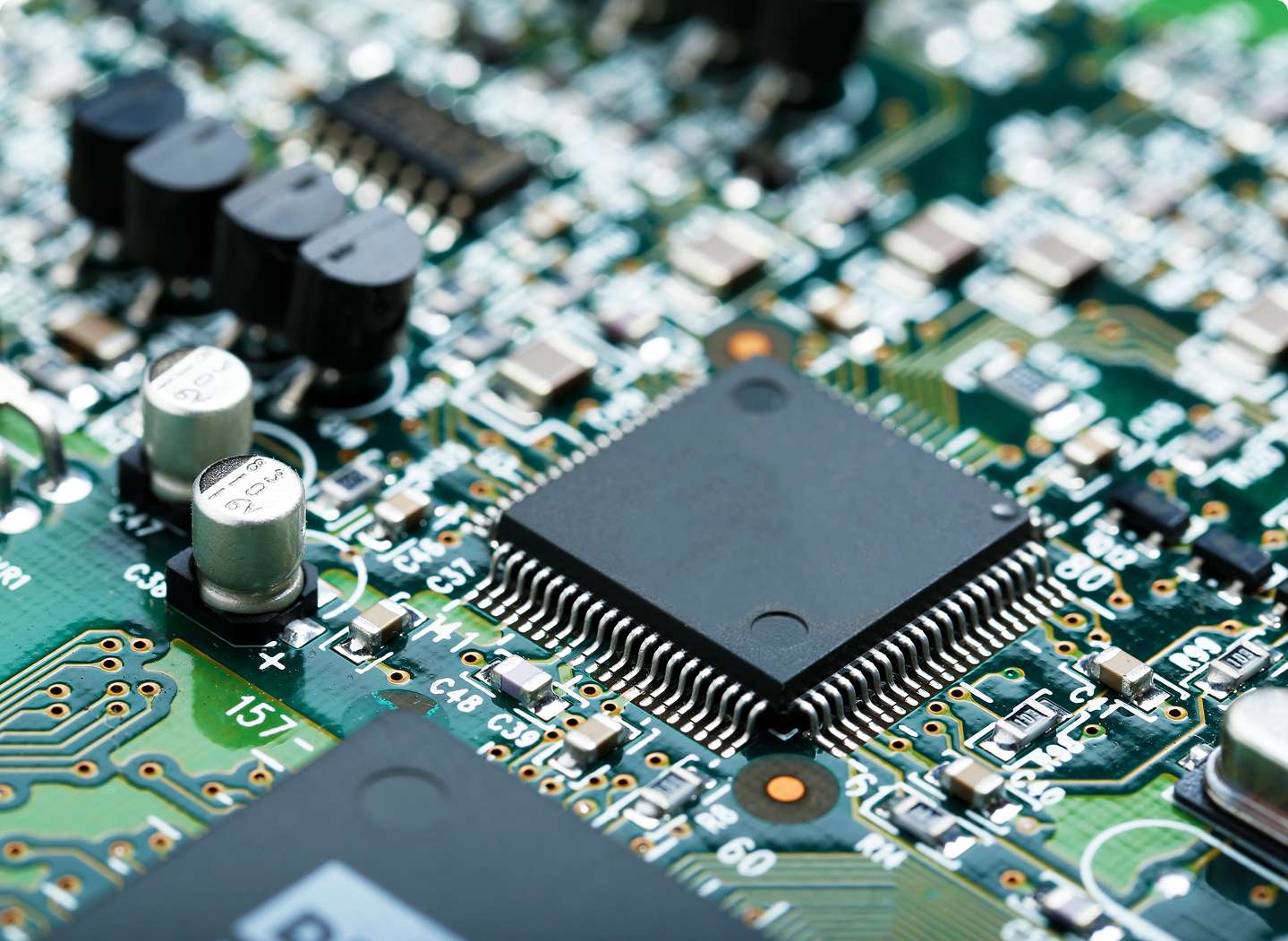 A close-up view of a microchip on a circuit board representing advanced embedded system services and hardware integration.