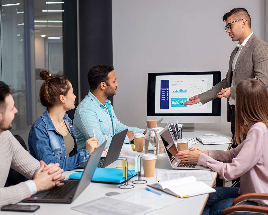 Team discussing sales data and lead tracking strategies during a meeting at a software solutions company.