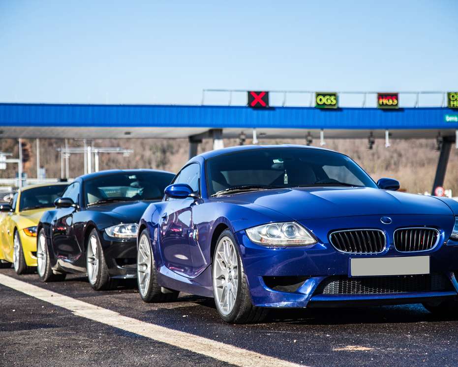 Cars passing through an automated toll system representing vehicle parking software solutions by a software development company.