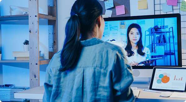 Professional analyzing surveillance footage on multiple monitors using advanced video analytics solutions in a modern control room.