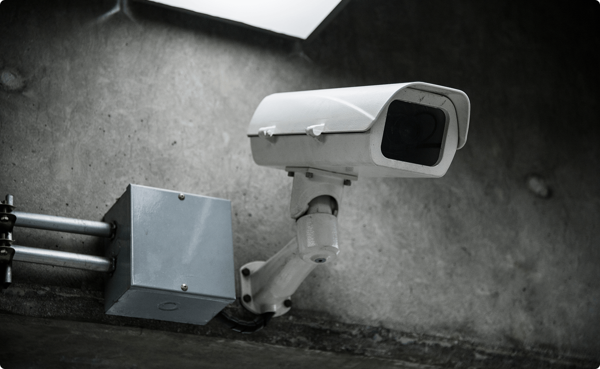 Wall-mounted security camera installed near an electrical junction box.