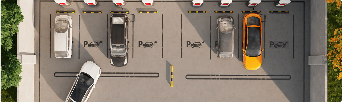 Top view of an automated parking lot with cars parked in marked spaces and charging symbols on the ground.